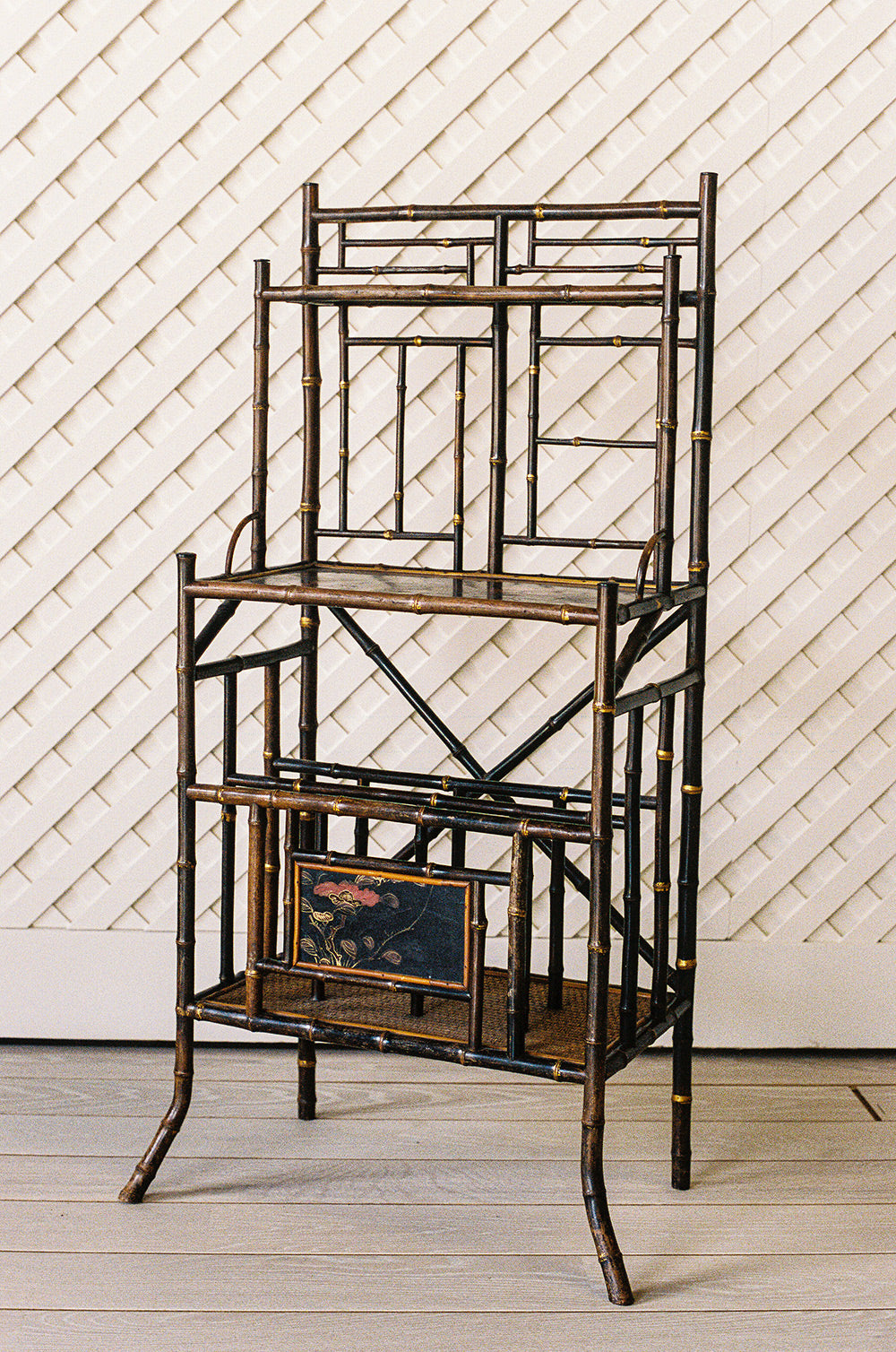 Victorian bamboo lacquer etagere with woven cane shelves and gilt accents, from the side