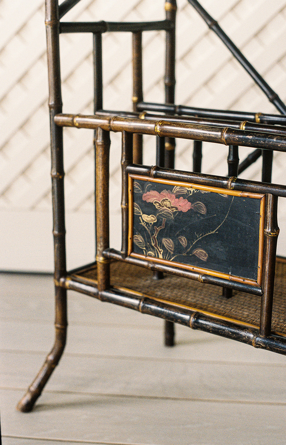 Victorian bamboo lacquer etagere with woven cane shelves and gilt accents, close view