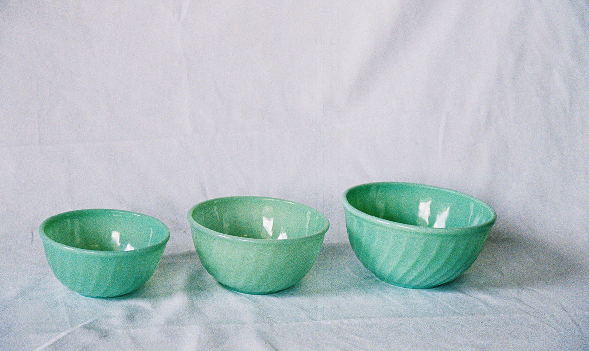 Three jadeite glass mixing bowls in graduated sizes