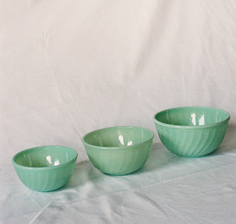 Three jadeite glass mixing bowls in graduated sizes