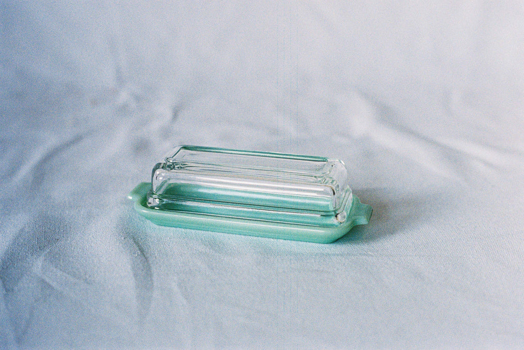 Jadeite glass butter dish with a clear glass lid
