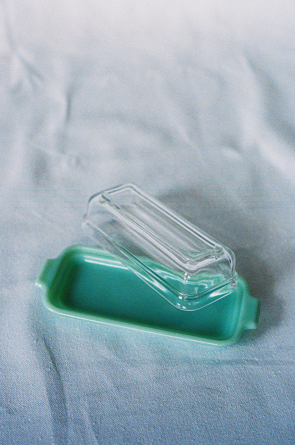 Jadeite glass butter dish with a clear glass lid