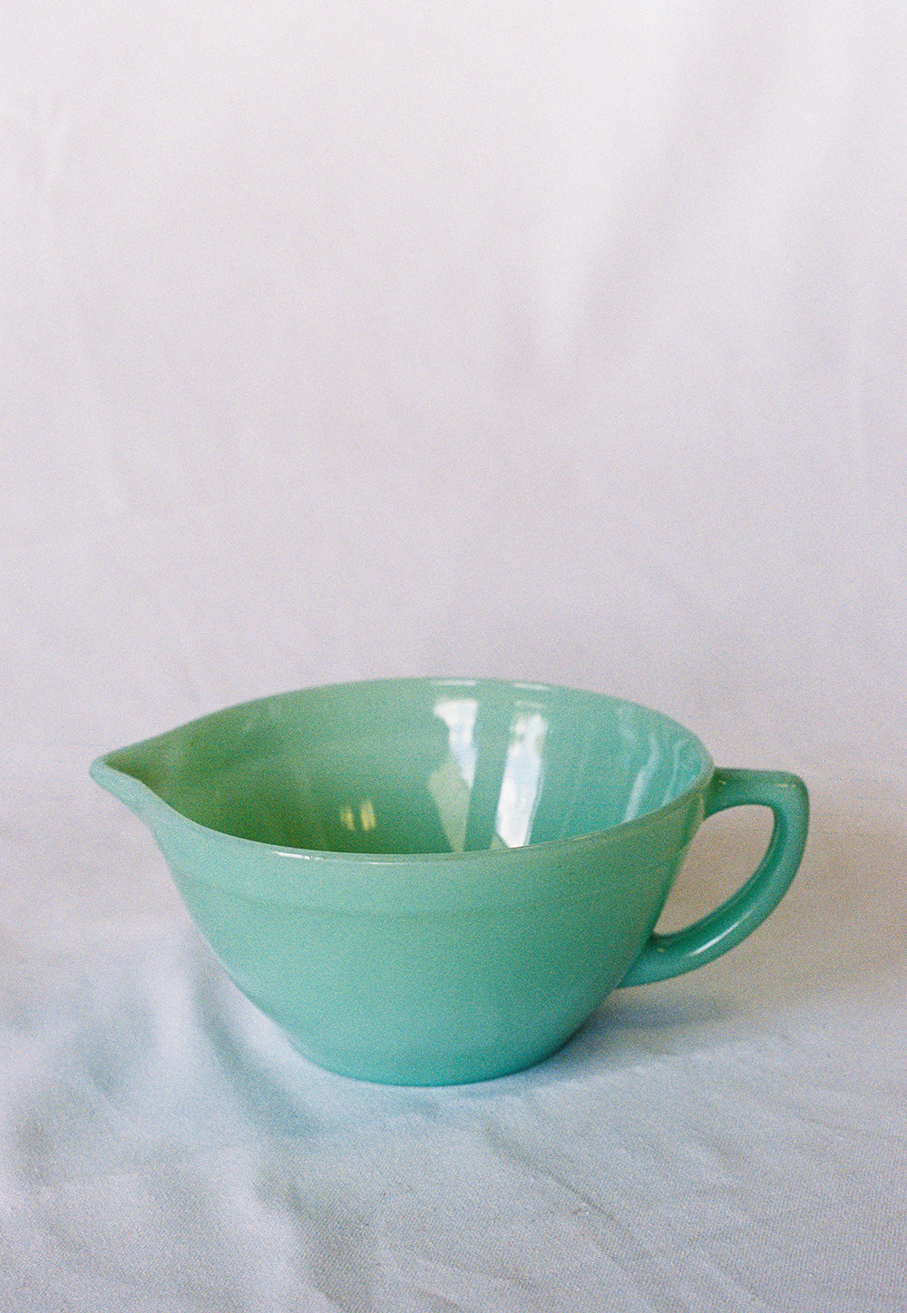 Jadeite glass mixing bowl with a handle and pouring spout