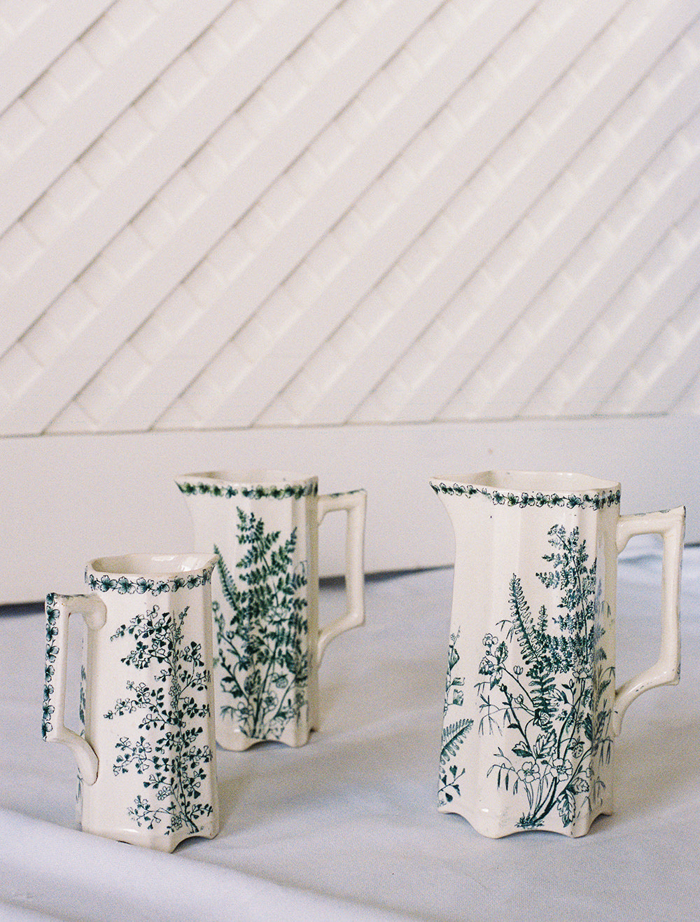 Three Victorian botanical transferware pitchers, upright