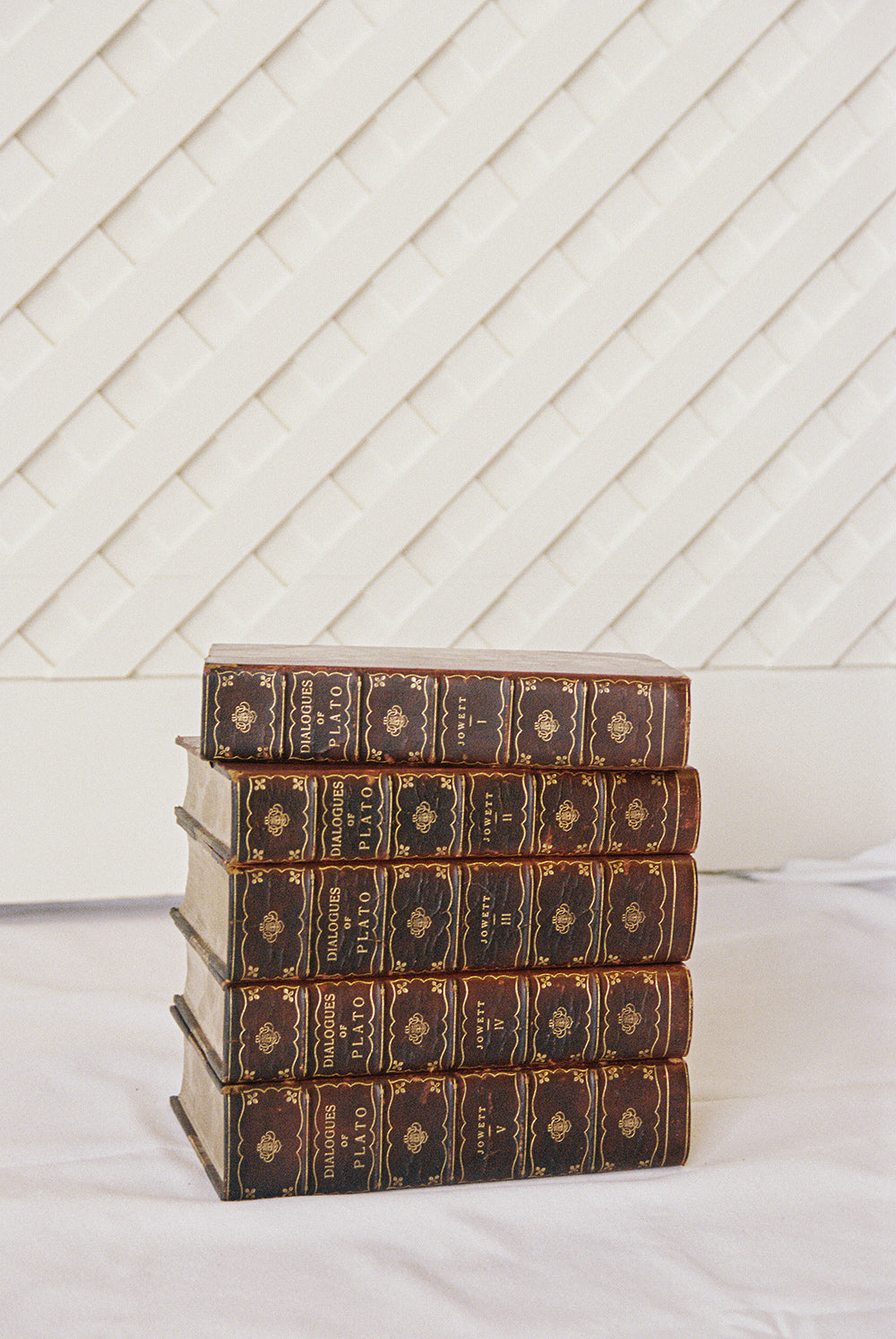 Five leather bound volumes of the Dialogues of Plato, translated by Jowett, with gilt tooled spines