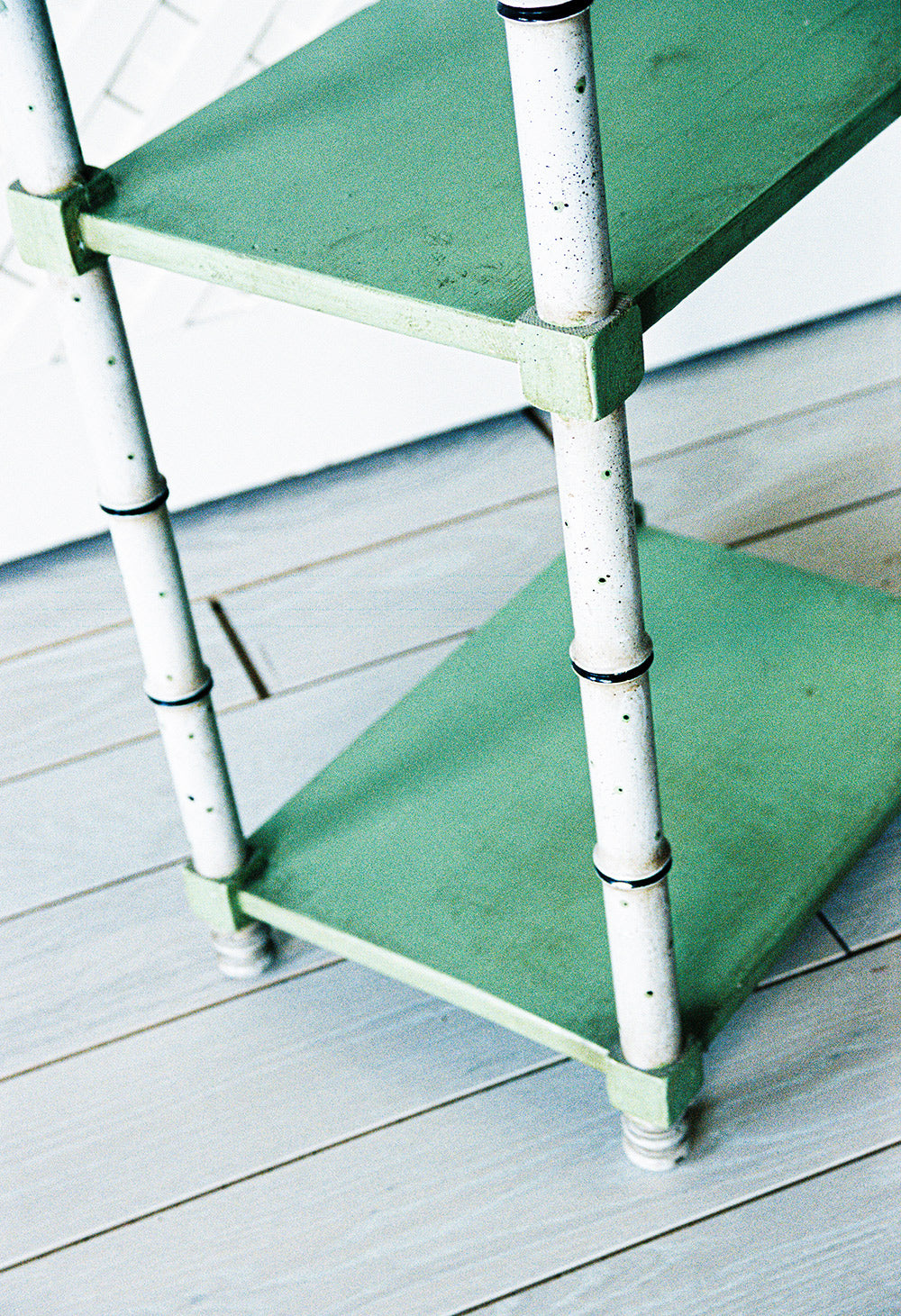 Faux bamboo etagere with green glazed shelves, close view