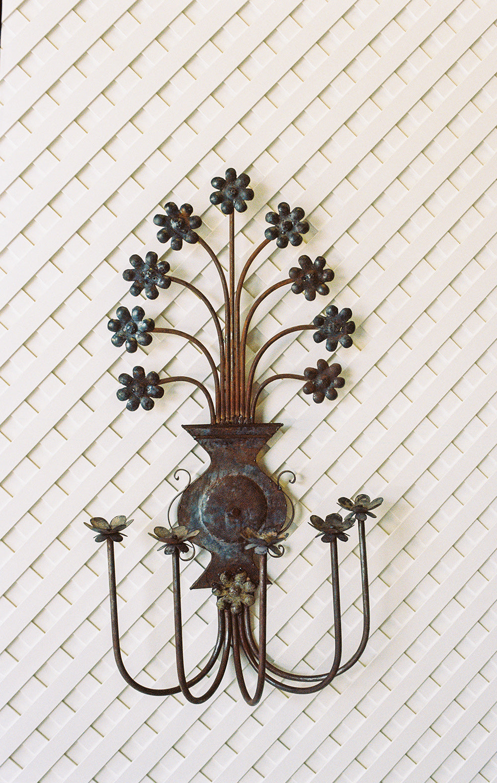 Pair of vintage floral metal candle sconces with a verdigris patina