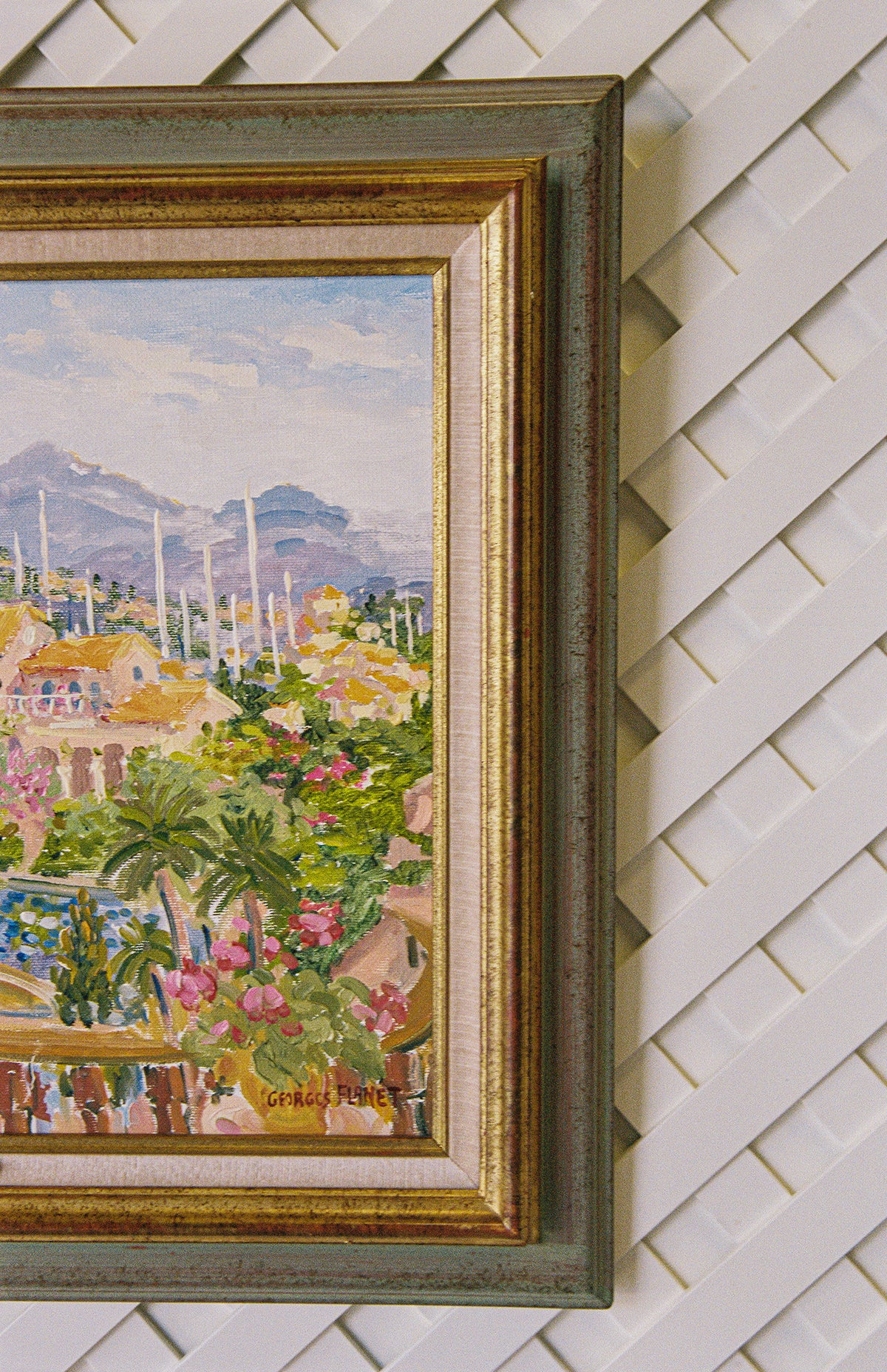 Angled close view of the Georges Flanet painting and its gilt and green frame