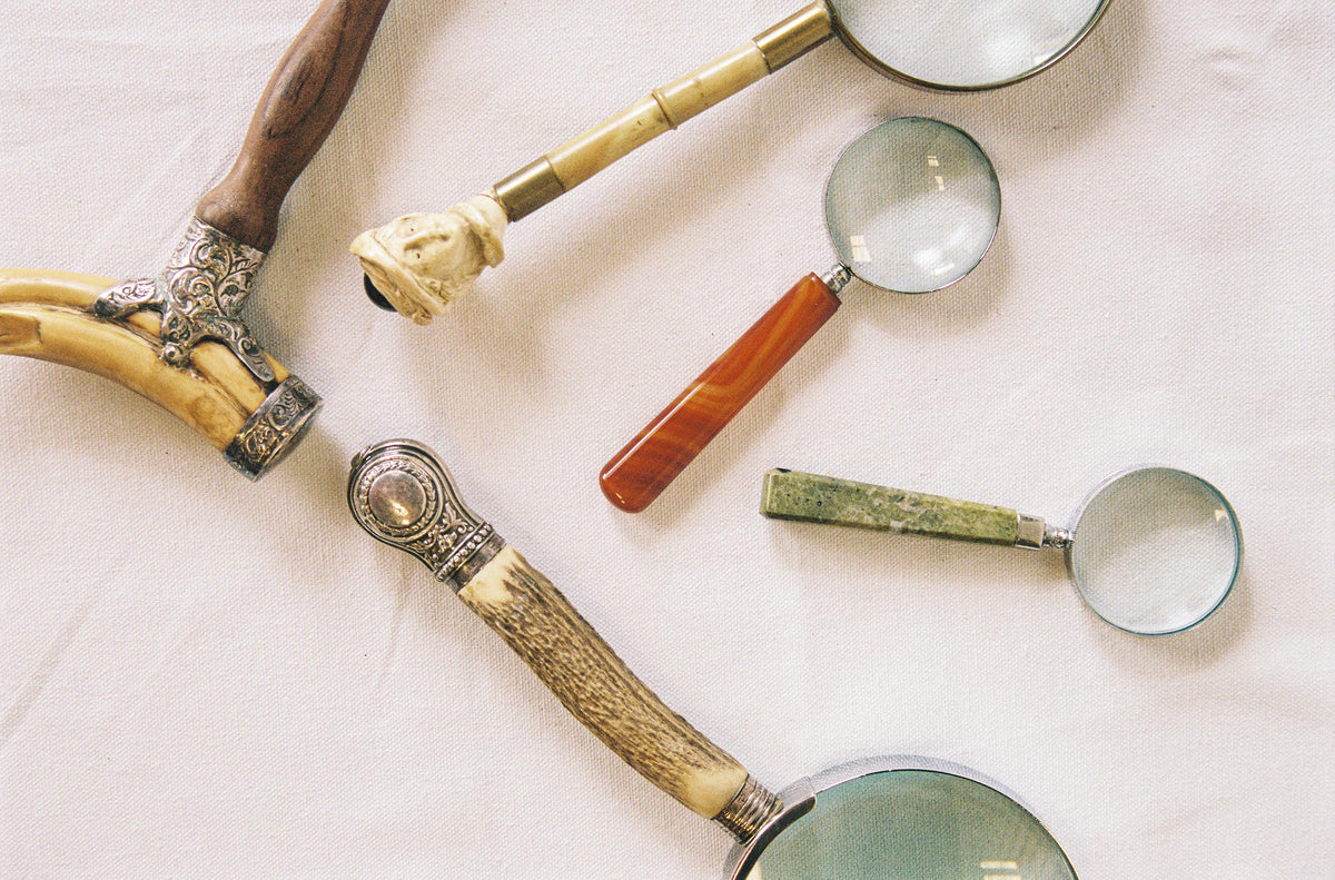 Five magnifying glasses with carved bone, hardwood and decorative metal handles