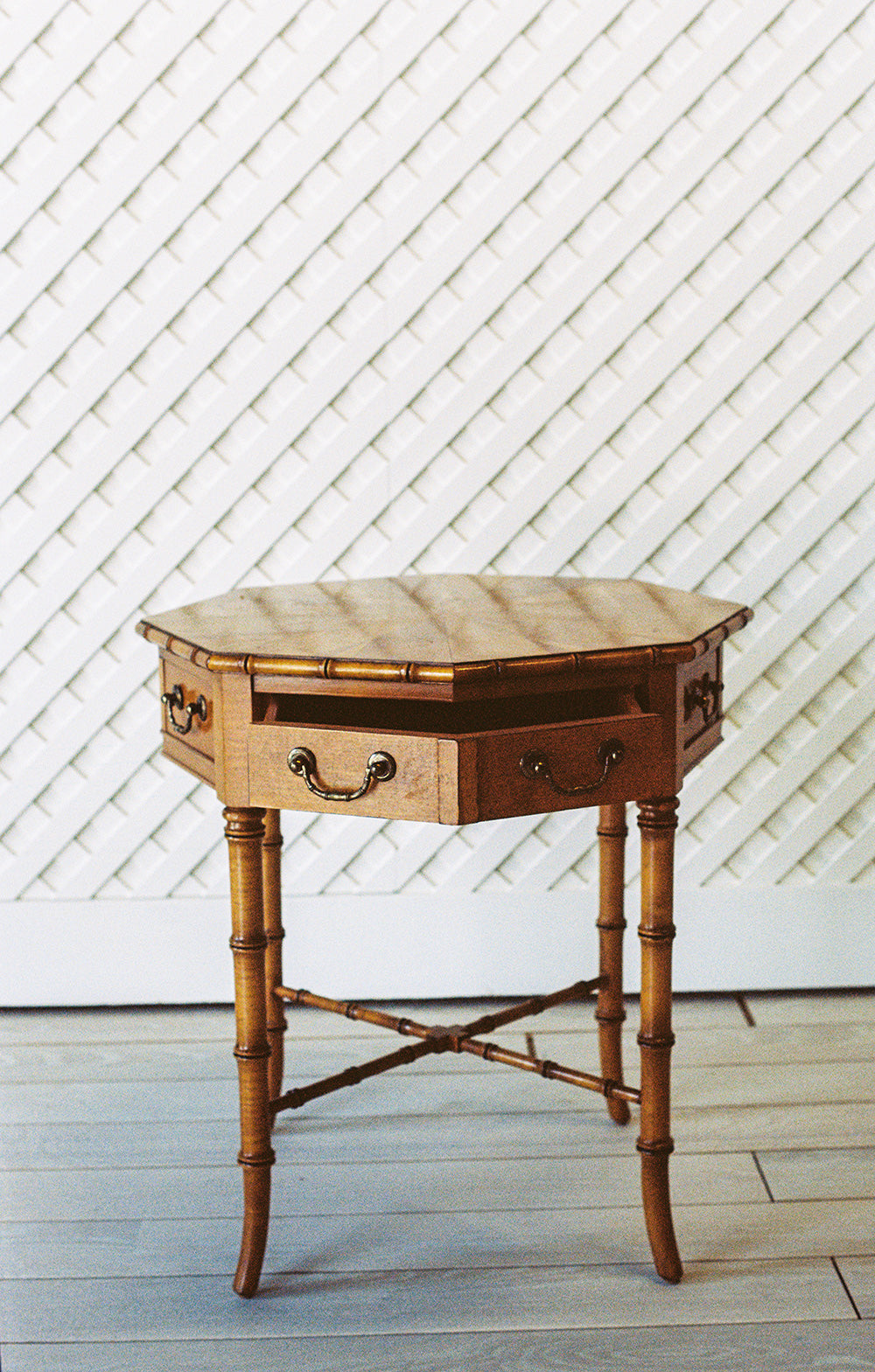 Octagonal bamboo end table with one drawer and a starburst veneer top