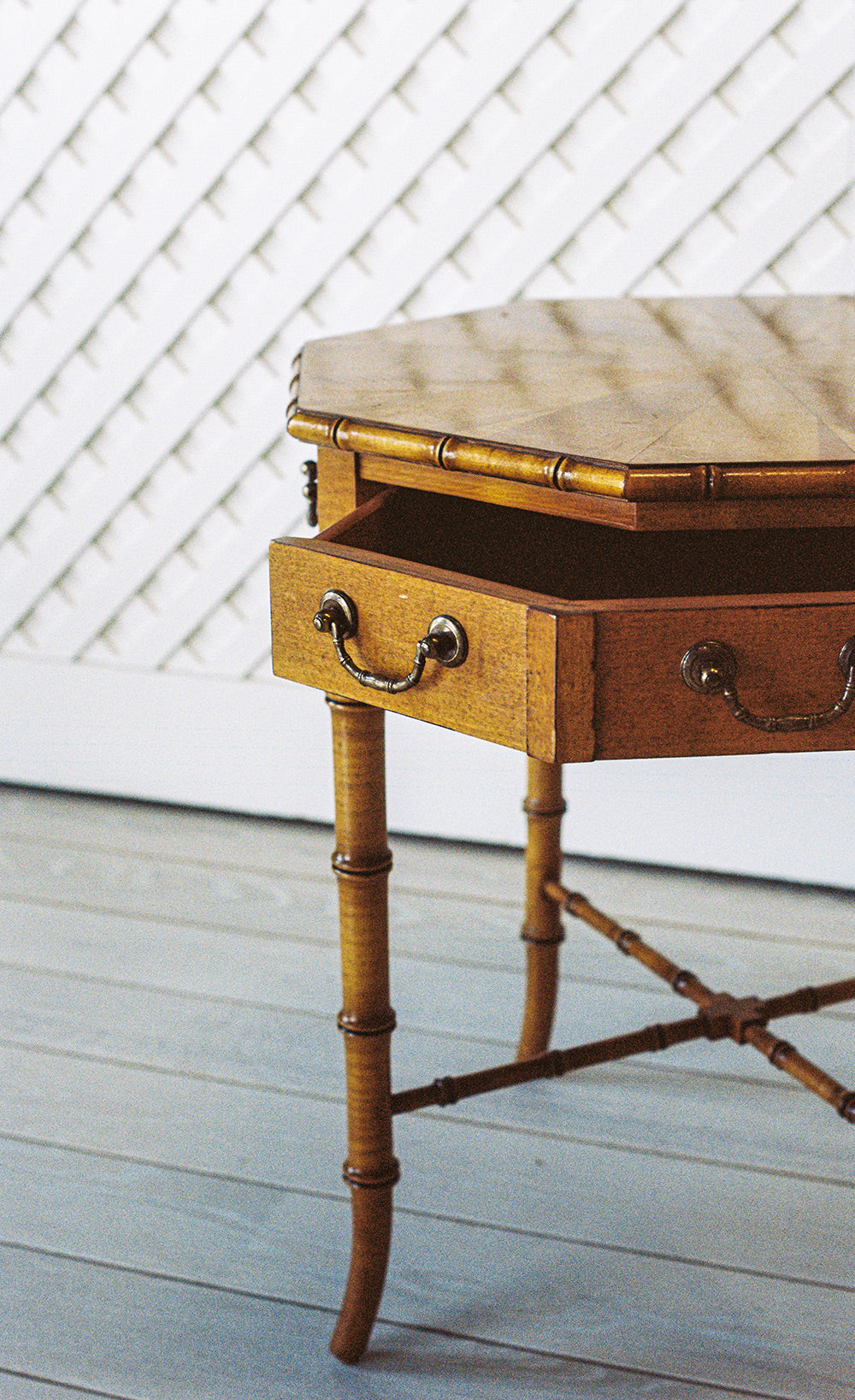 Octagonal bamboo end table with one drawer and a starburst veneer top