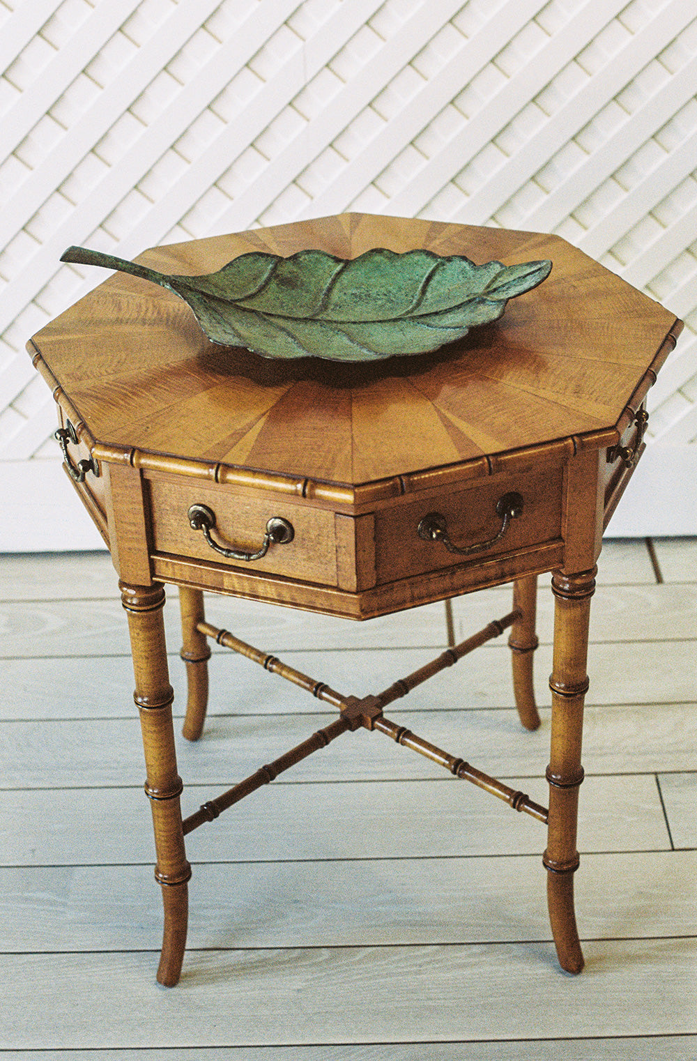 Octagonal bamboo end table with one drawer and a starburst veneer top