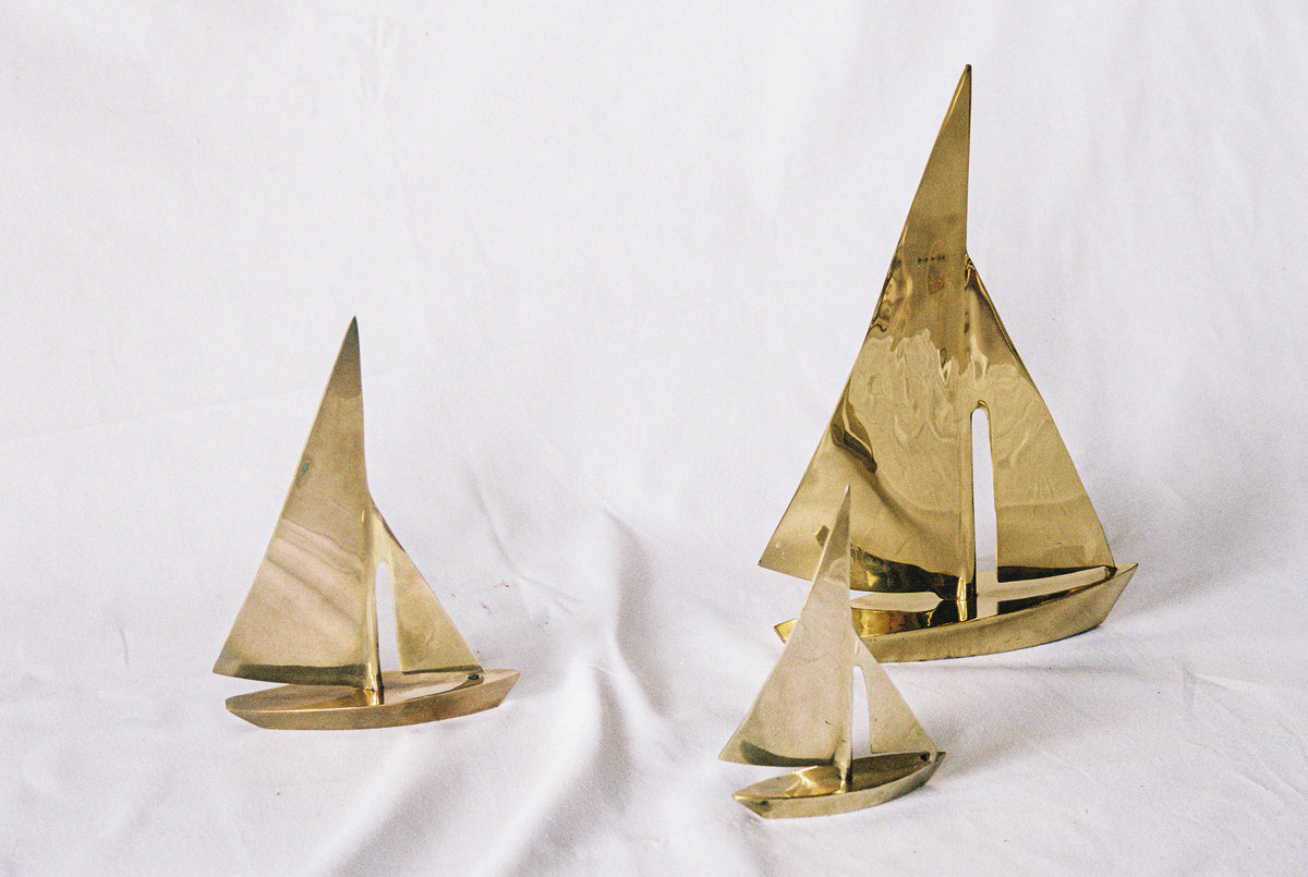 Three solid brass sailboats in graduated sizes