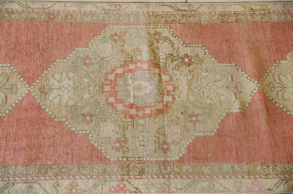 Oushak wool runner with three medallions in pink, tan and cream, close view